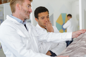 portrait of supervisor inspecting wall paper
