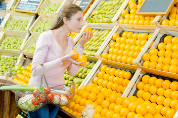 a girl basket and oranges
