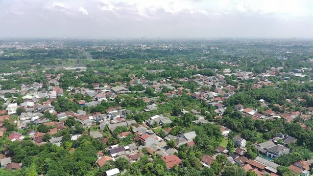 4K footage aerial view of residential area filled with greenery.