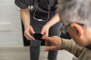 elderly man and nurse measuring pulse oximeter