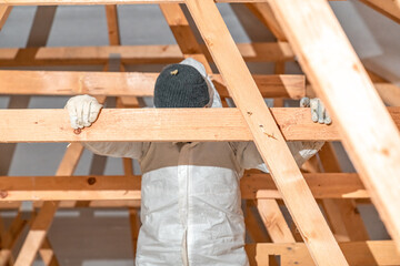 work on the attic of the house, insulated with glass wool