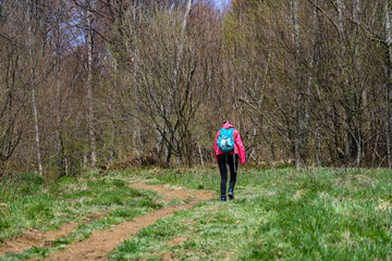 Backpacker girl enjoys a hike during spring in the Bieszczady Mountains, Poland, Europe