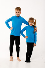 Fototapeta premium A little girl and her older brother in thermal clothes.