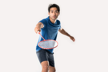 Badminton player in sportswear stands holding a racket and shuttlecock in the white background