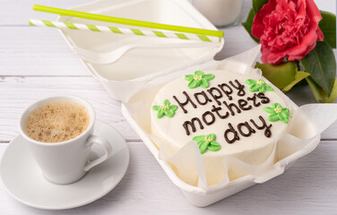 Happy mother's day cake, flower and coffee cup on white table. Happy mother's day concept