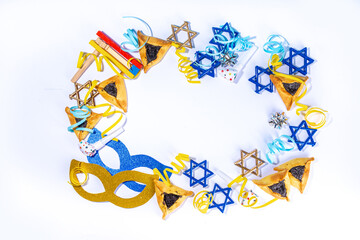   Jewish holiday Purim greeting card background, jewish spring start holiday carnival flat lay with traditional carnival masks, rattle, gifts and hamantaschen cookie on white background