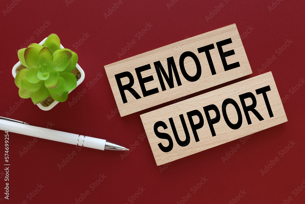 Poster Remote Support close-up on wooden blocks with text.pen points to the text