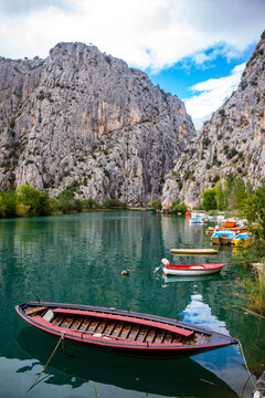 panorama of the town of omis in croatia on the adriatic coast; the famous old town at the mouth of the cetina river; old buildings surrounded by huge mountains in a canyon