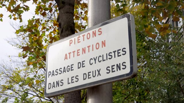 "Pedestrians beware, cyclists pass in both directions" French sign
