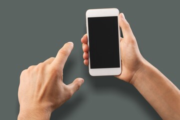 Hands hold a phone with a blank screen