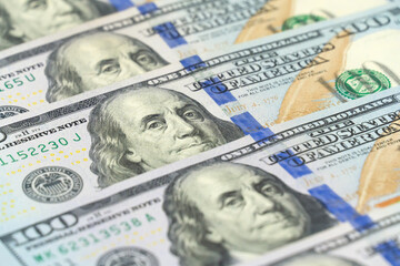 Macro photography of 100 dollar bills in a row. International currency. Background of dollar bills.