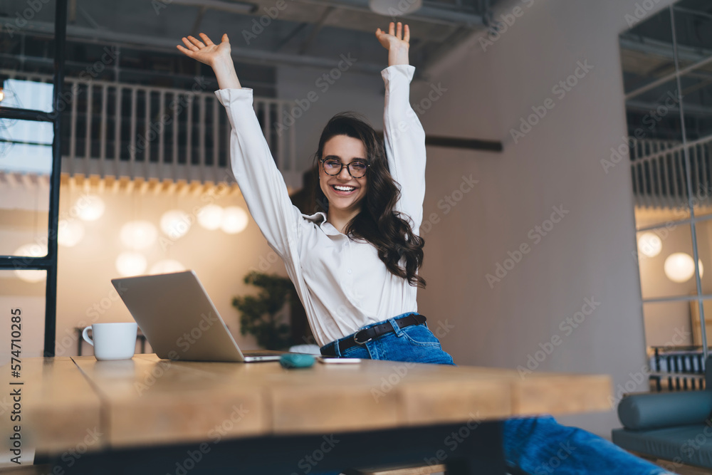 Sticker cheerful young freelancer with raised arms