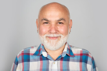 Fototapeta premium Portrait of happy senior man smiling. Face of 50s aged pensioner. Portrait of senior man in studio. Grey hair senior model. Old male portrait.