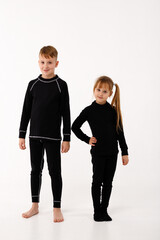 A little girl and her older brother in thermal clothes.