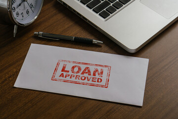 Loan approved word by rubber stamping on envelope.Loan business finance economy commercial real...