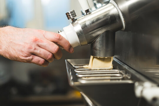 Pouring ice cream from pasteurizer and batch freezer machine. High quality photo