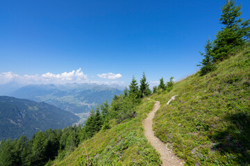 Endless view from high up in the mountains towards the blue sky and other summits