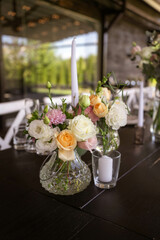 A very nicely decorated wedding table appointments with beautiful decor with plates and serviettes in spring garden. Beautiful flowers on table in wedding day. The elegant dinner table.