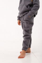 Little girl in thermal clothes, on a white background.