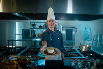 Chef showing the dish he cooked. Offering to the camera.