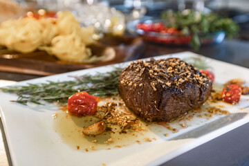 Beautiful gourmet dish with meat and tomatoes. spices in the composition. Wine glass.