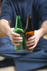 person holding empty beer bottles