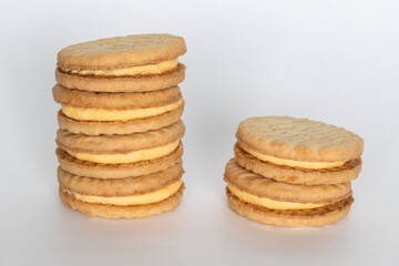 Sandwich cookies with cream on white background.