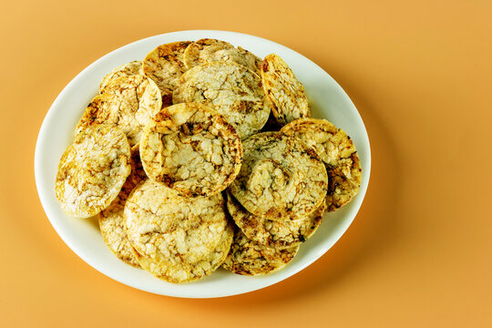 A Pile Of Brown Rice Chips With Spices On A Plate