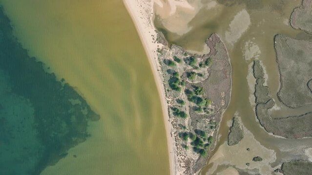 Aerial shot of a lagoon behind a beach