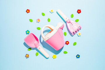 Children's toy tools for gardening on a blue background
