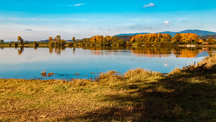 Beautiful autumn or indian summer landscape view with reflections at Mettenufer, Danube, Bavaria, Germany