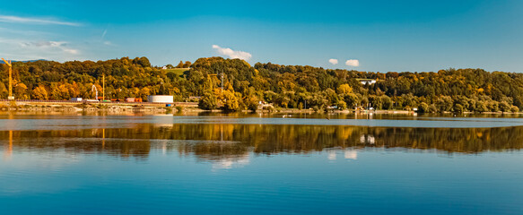 Fototapeta na wymiar Beautiful autumn or indian summer landscape view with reflections at Mettenufer, Danube, Bavaria, Germany