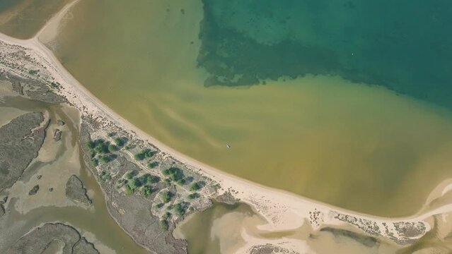 Aerial shot of a lagoon behind a beach