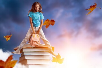 Happy cute child with stak of books
