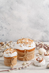 Traditional easter cake or sweet bread, pussy willow twigs, quail eggs and white meringues in shape...