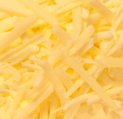 Grated cheese as a textured background. Gouda cheese wallpaper.