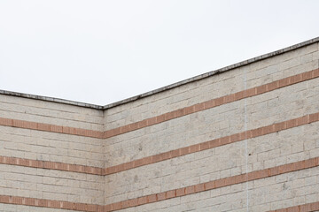 Urban abstract architecture.. close up of a facade with grey sky.