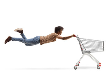 African american guy flying and holding a shopping cart © Ljupco Smokovski