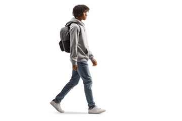 Full length profile shot of an african american male student walking