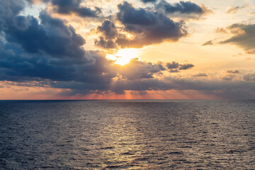 Fototapeta premium Dramatic Colorful Sunset Sky over Mediterranean Sea. Clouds with Sunrays. Cloudscape Nature Background.