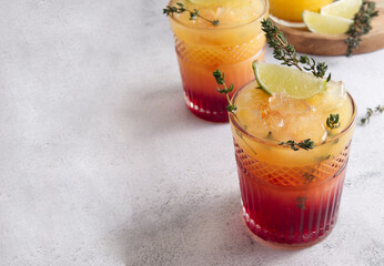 Fresh cocktails with ice, orange juice and grenadine syrup decorated with berries copy space