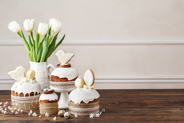 Set of traditional easter cakes with icing, decorated with gingerbread cookies over wooden table...