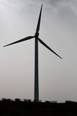 windmills, on the crest of a mountain, producers of electricity, clean and renewable, on a cloudy winter day