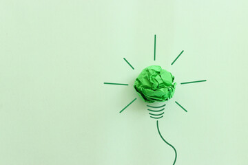 Concept image of green crumpled paper lightbulb, symbol of scr, innovation and eco friendly business