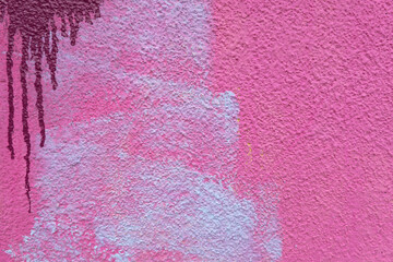 Pink, magenta, white painted grunge plaster wall surface background with colorful drips, flows,...