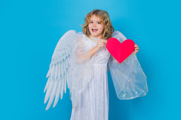 Child with angel wings hold paper heart. Symbol love and valentines day. Cute angel kid, studio...