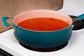 Simmering Pot of Steaming Tomato Soup On Stove Top