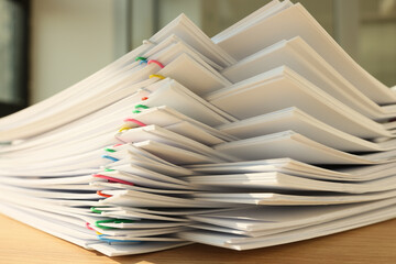 A stack of paper with colored paper clips, close-up