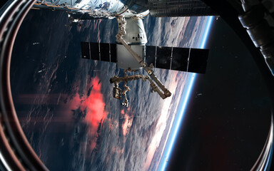 ISS in orbit of planet Earth. View from porthole. Solar system. Science fiction. Elements of this image furnished by NASA