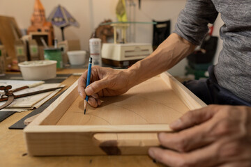 Fototapeta na wymiar gentleman drawing his ideas by hand in his workshop